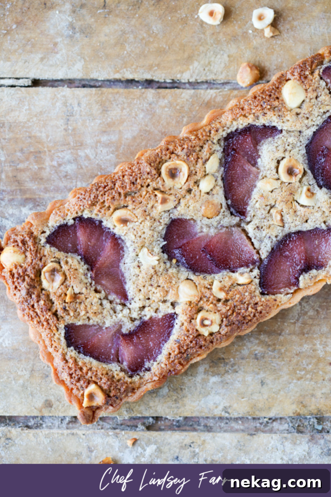The Hazelnut Pear Tart ready to be sliced, a perfect dessert for any gathering.