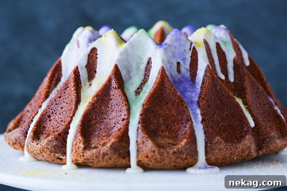 A slice of Mardi Gras Bundt Cake with Bourbon glaze being served