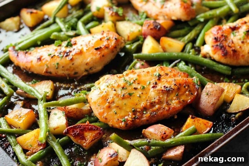 Sheet Pan Honey Garlic Chicken and Roasted Vegetables 5 A close-up view of a perfectly roasted honey garlic chicken breast, glistening with glaze.