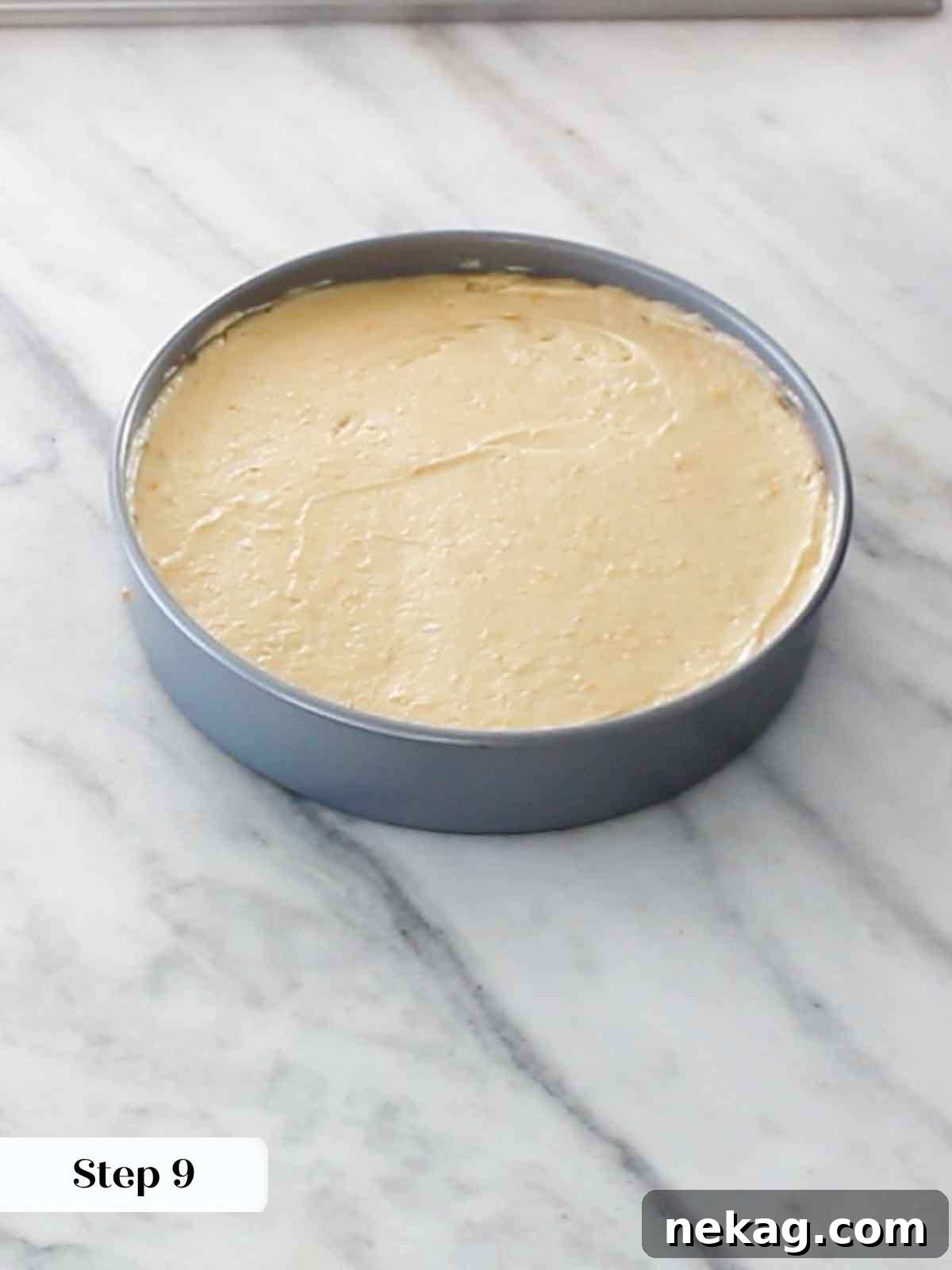 Smooth cake batter evenly spread in the pan, ready for baking.