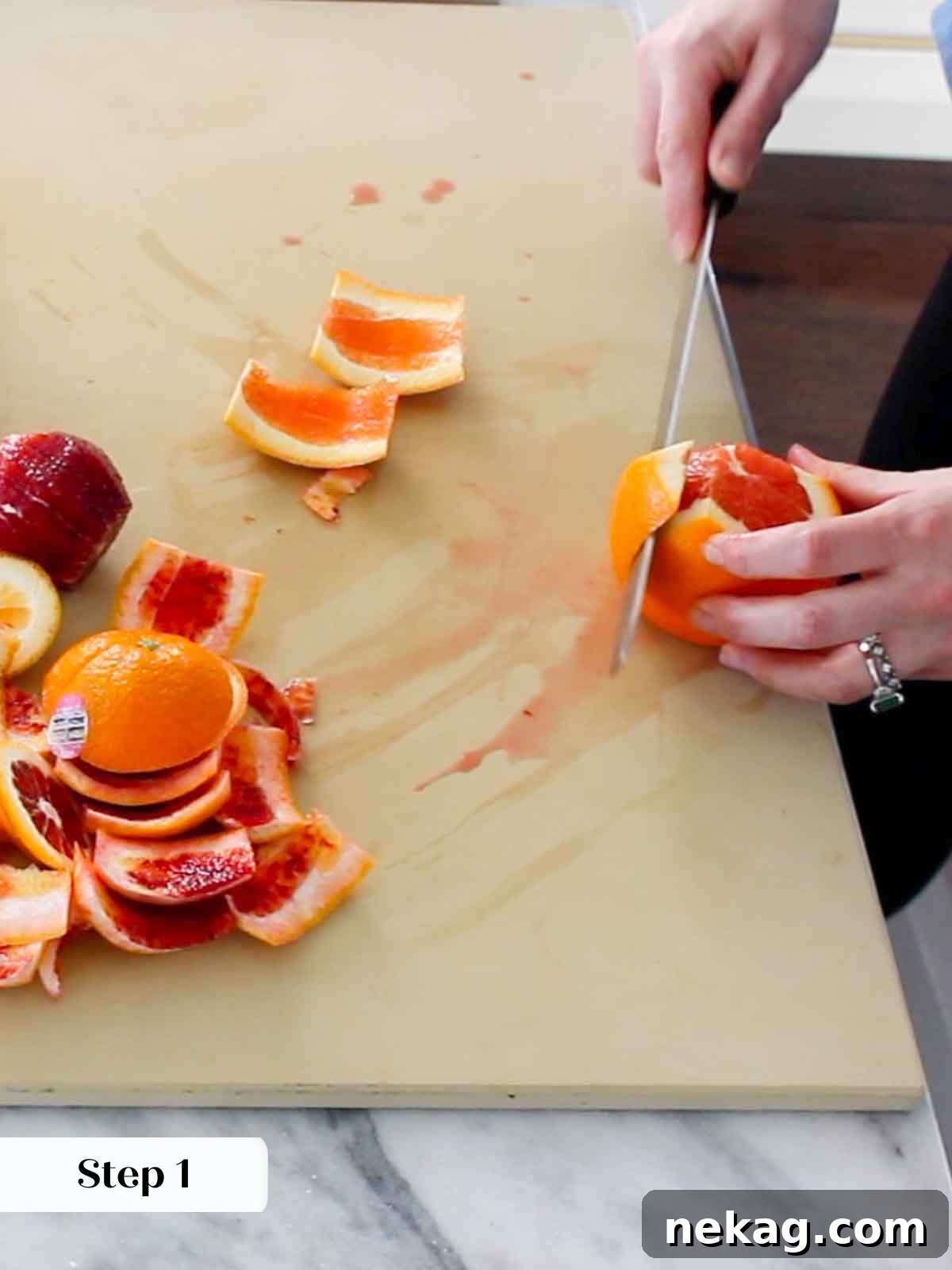 Expertly removing orange peel for supremes, showcasing the technique.