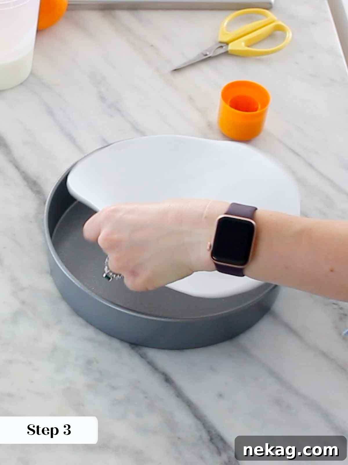 Lining the cake pan with parchment paper, ensuring easy removal.