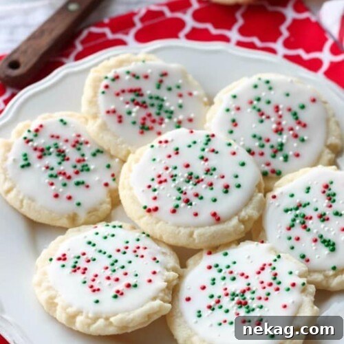 Christmas Meltaway Cookies with white glaze and colorful sprinkles