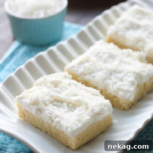 Delicious Coconut Sugar Cookie Bars with frosting and coconut flakes.