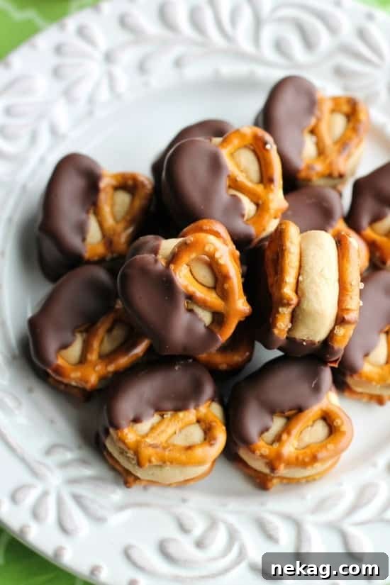 A hand holding a Peanut Butter Pretzel Bite, showing the inside texture.