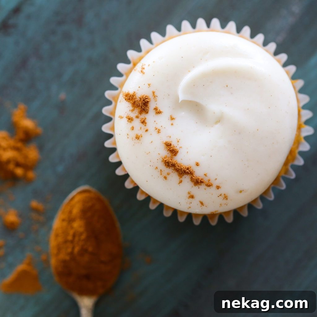 Decadent Pumpkin Cream Cheese Cupcakes 4 Close-up of a perfectly frosted Pumpkin Spice Cupcake with Maple Cream Cheese Buttercream