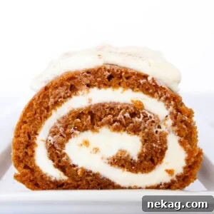 sliced pumpkin roll cream cheese filling, garnished with powdered sugar.