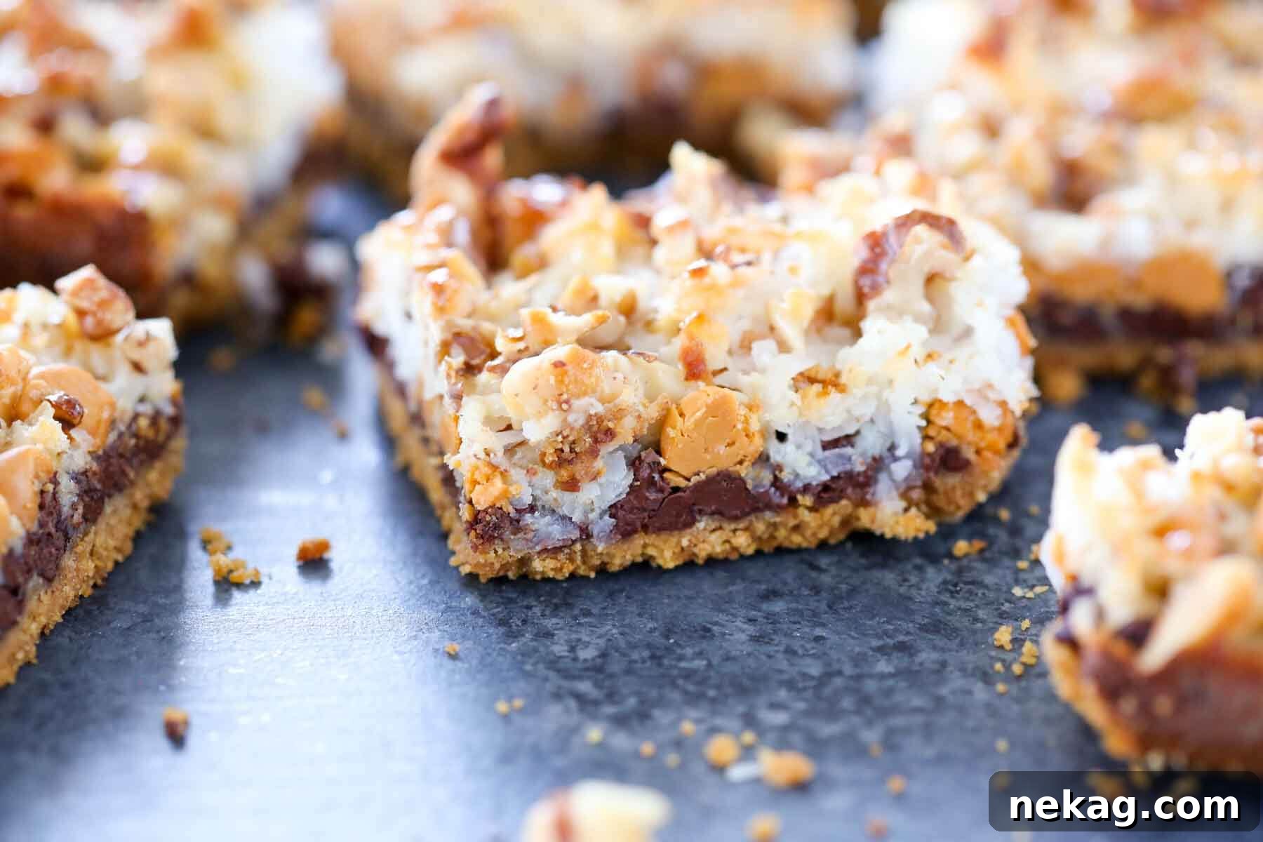 Enchanted Stacked Delights 3 single 7 layer bar with toasted coconut.