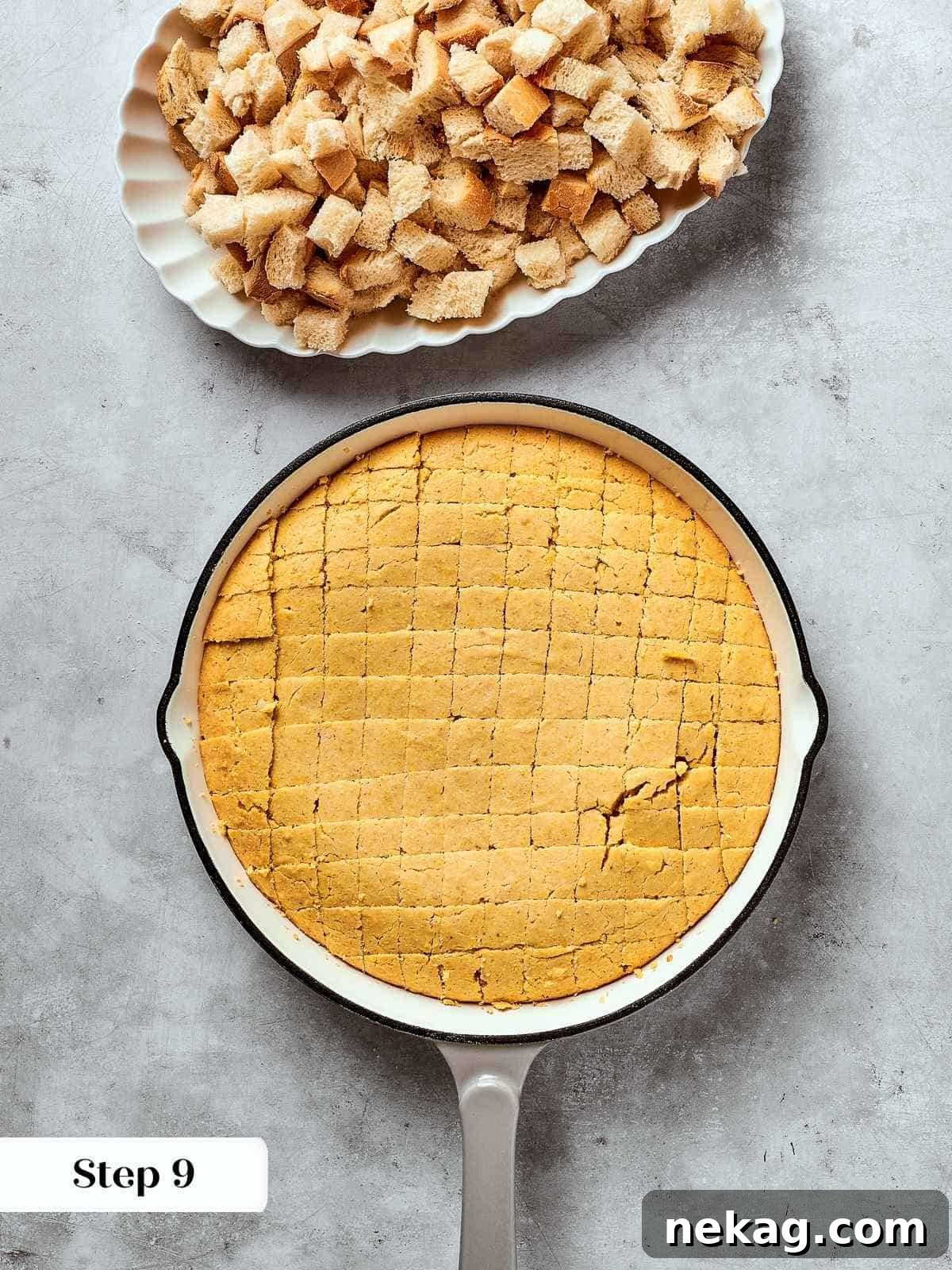 Freshly baked cornbread, golden and inviting, expertly cut into uniform cubes and cooling in a pan.