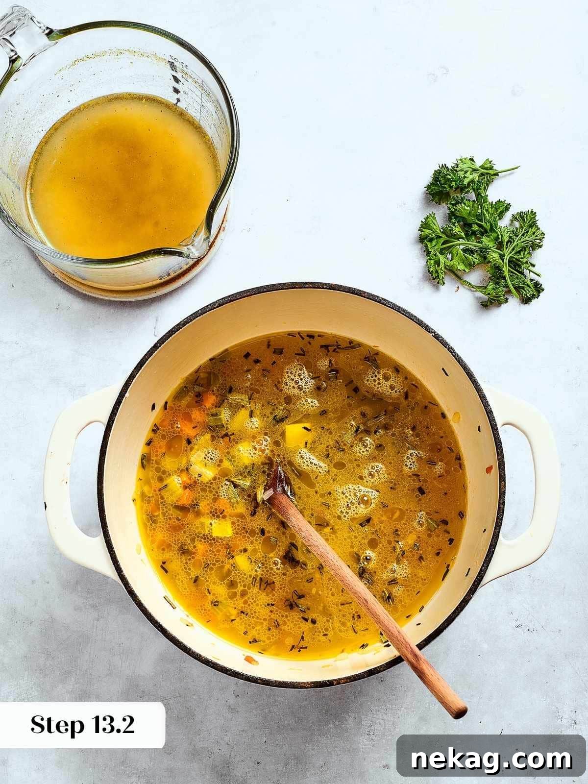 Rich chicken broth being poured into the sautéed vegetable and herb mixture, simmering to meld all the savory flavors.
