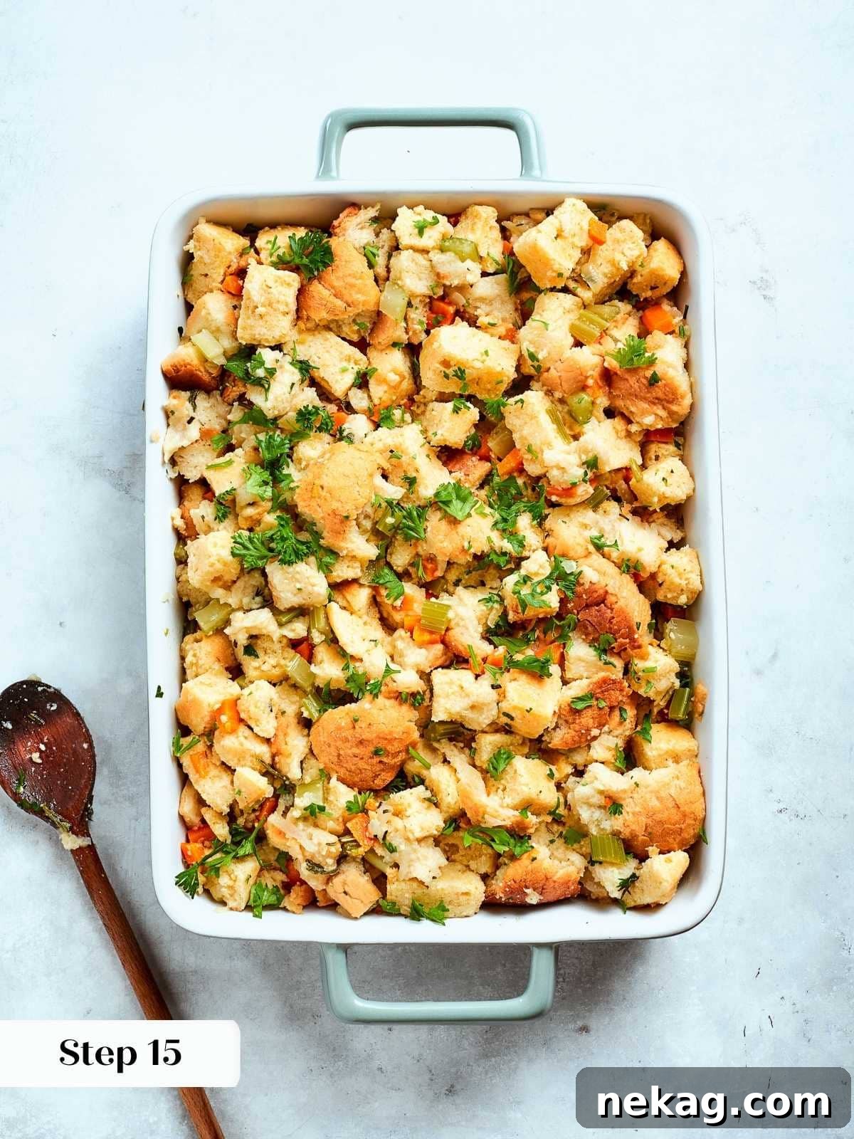 Unbaked cornbread stuffing mixture, beautifully combined with vegetables and herbs, arranged evenly in a baking dish.