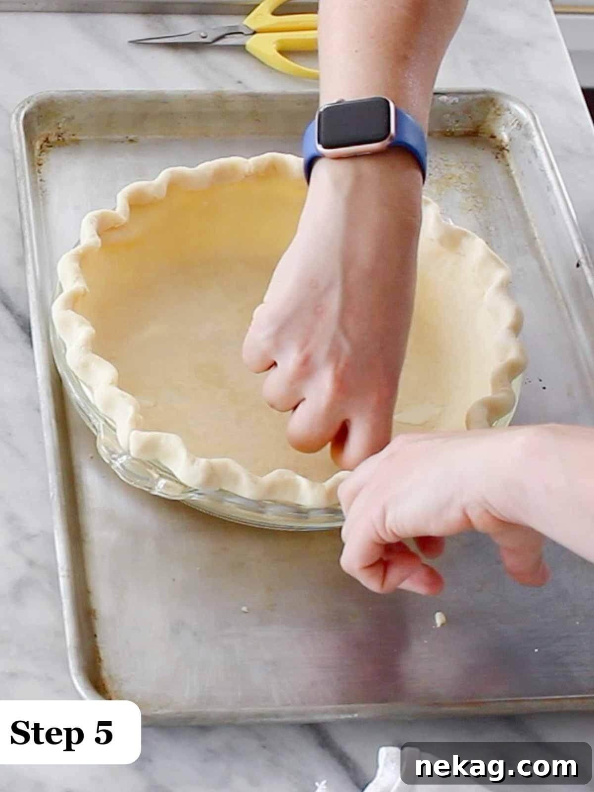 Decadent Chocolate Pecan Pie 6 Step-by-step image detailing the technique of fluting a pie crust edge around a tin for a decorative finish.