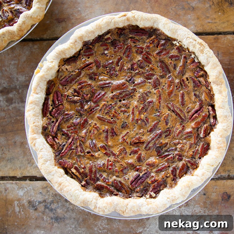 Decadent Pecan Pie Perfection 9 A whole, unsliced classic pecan pie, showcasing its beautifully golden and nutty top layer.