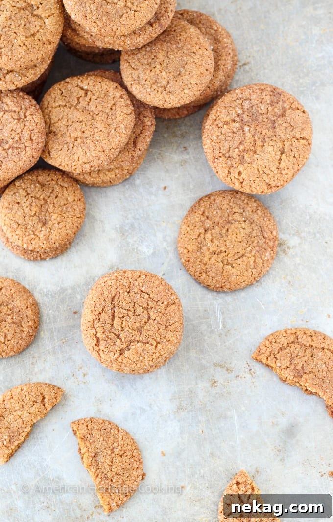 An array of Old Fashioned Gingersnaps artfully arranged on a serving platter, showcasing their uniform shape and inviting cinnamon-sugar coating.