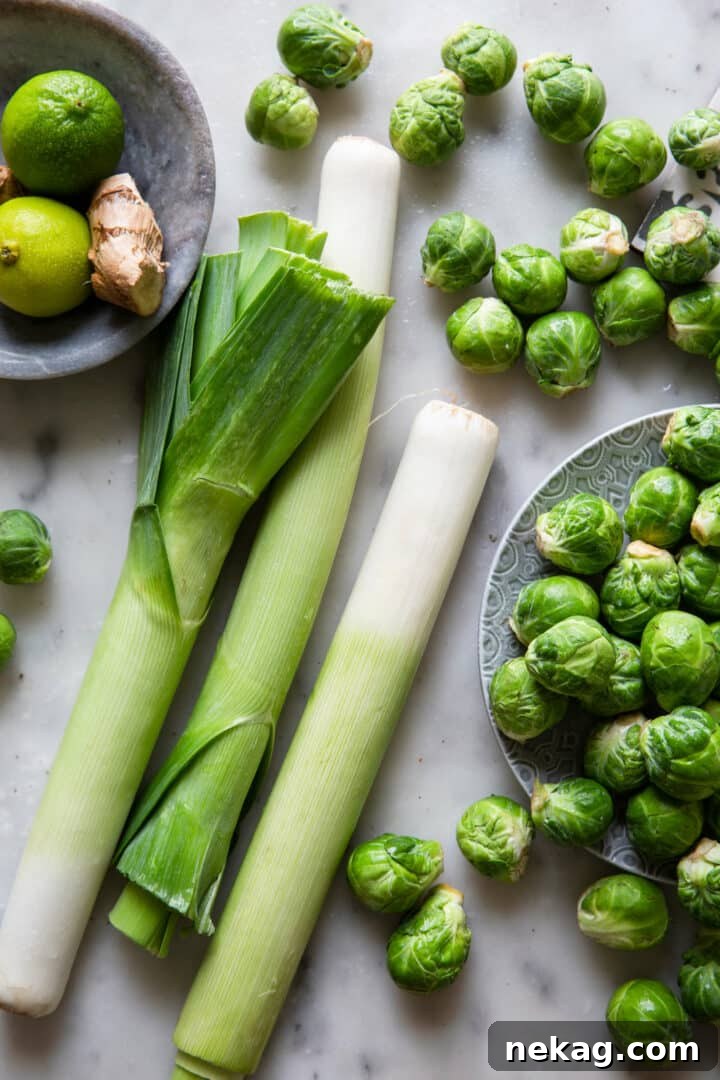 Zesty Lime-Ginger Buttered Brussels Sprouts and Leeks 3 Close-up of Cooked Brussels Sprouts and Leeks on a Grey Surface