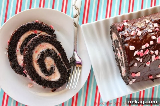 A close-up of a perfectly sliced Dark Chocolate Peppermint Roll, showcasing the creamy peppermint filling.