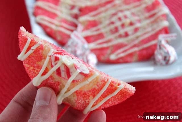 Holiday Peppermint Thumbprint Cookies 3 Close-up of peppermint thumbprint cookie dough being coated in red sugar crystals.