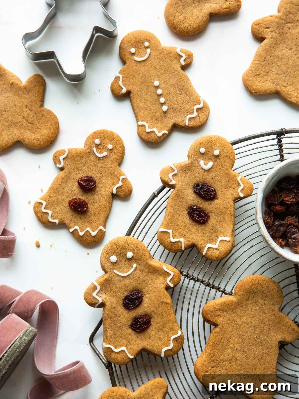 Freshly baked soft gingerbread cookies cooling on a wire rack, evoking warm holiday feelings.