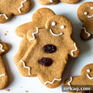 A charming gingerbread man cookie, lovingly adorned with simple raisin features, ready for the holidays.