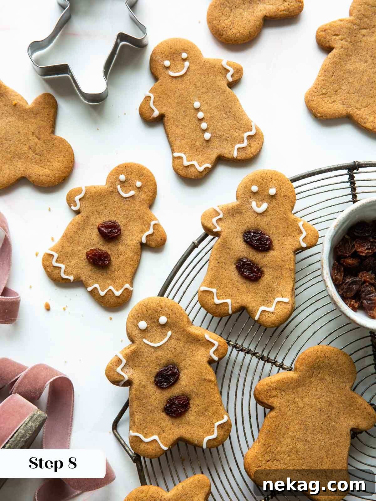 A tray of beautifully baked and decorated gingerbread cookies, glistening and arranged, exuding festive appeal and ready to be enjoyed.