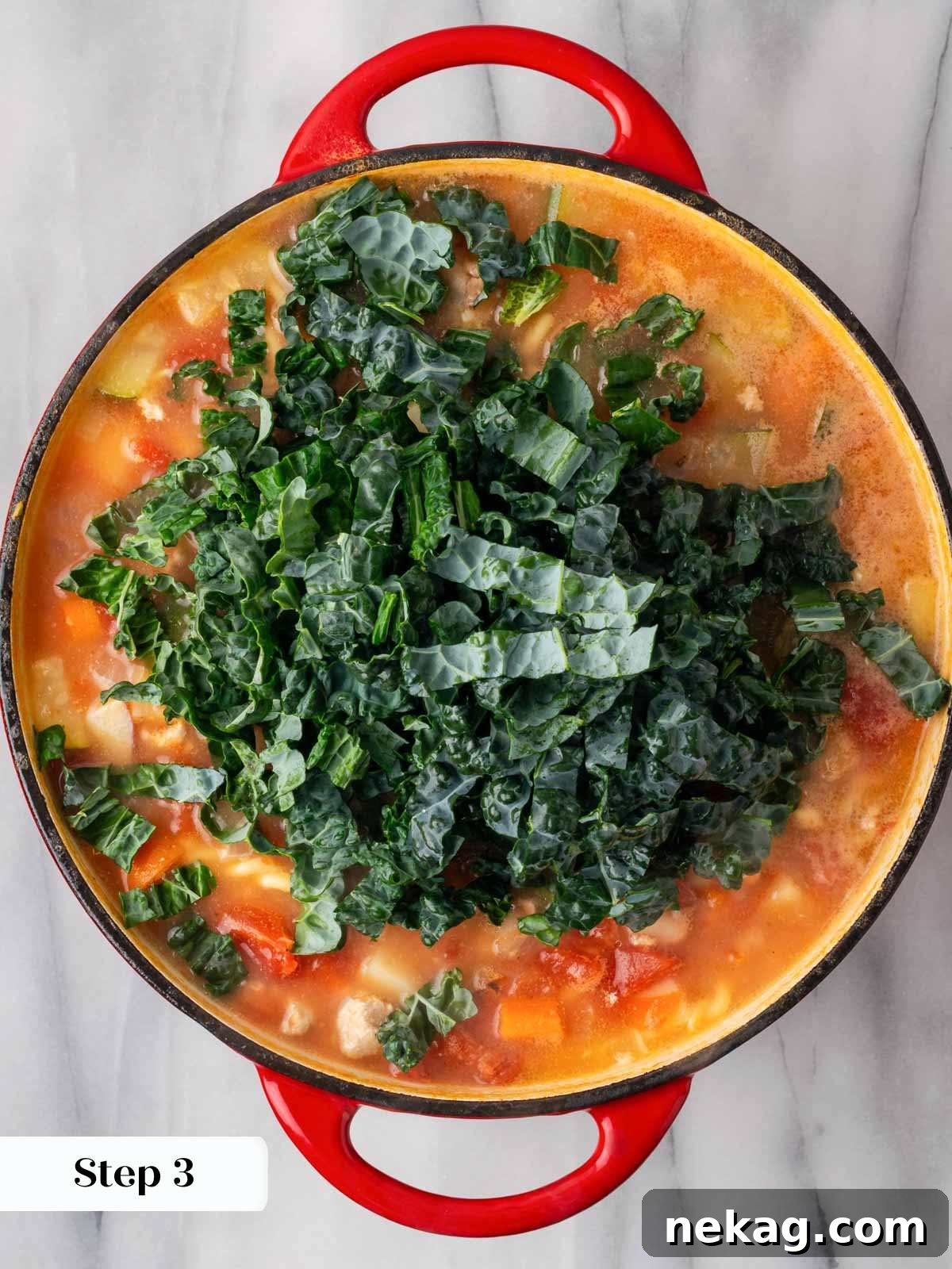 Hearty Ground Turkey Soup 7 adding kale to cooking soup.