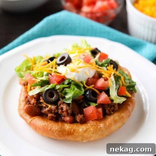 Easy Navajo Tacos (Indian Fry Bread) with savory beef and bean filling and fresh toppings.