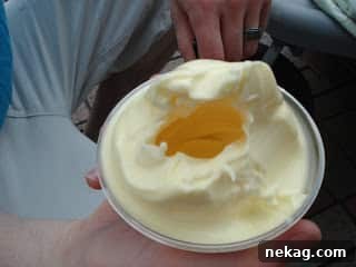 My Disney Magic Revealed 13 Dole Pineapple Whip with a noticeable unfilled space in the center of the cup