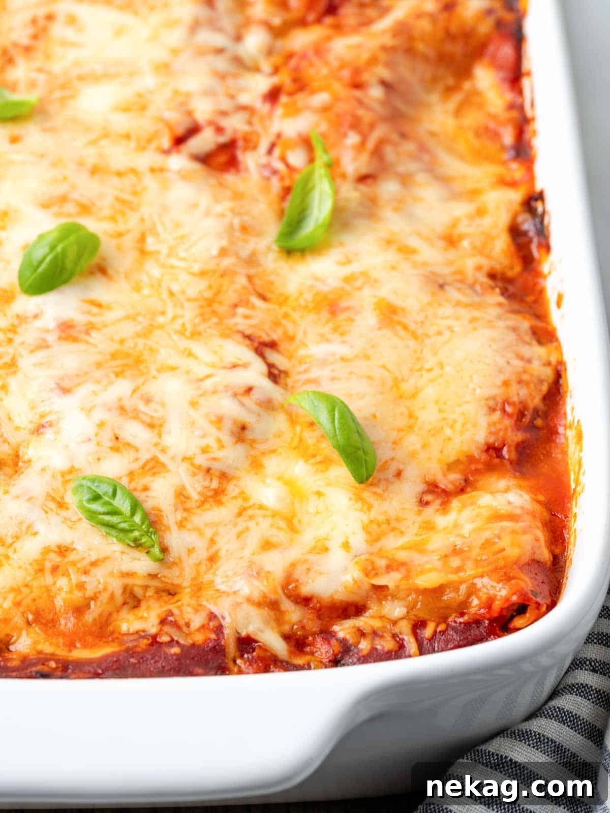 Seasonal Vegetable Lasagna 13 A freshly baked vegetable lasagna, still bubbling hot from the oven, with a golden-brown cheese topping.