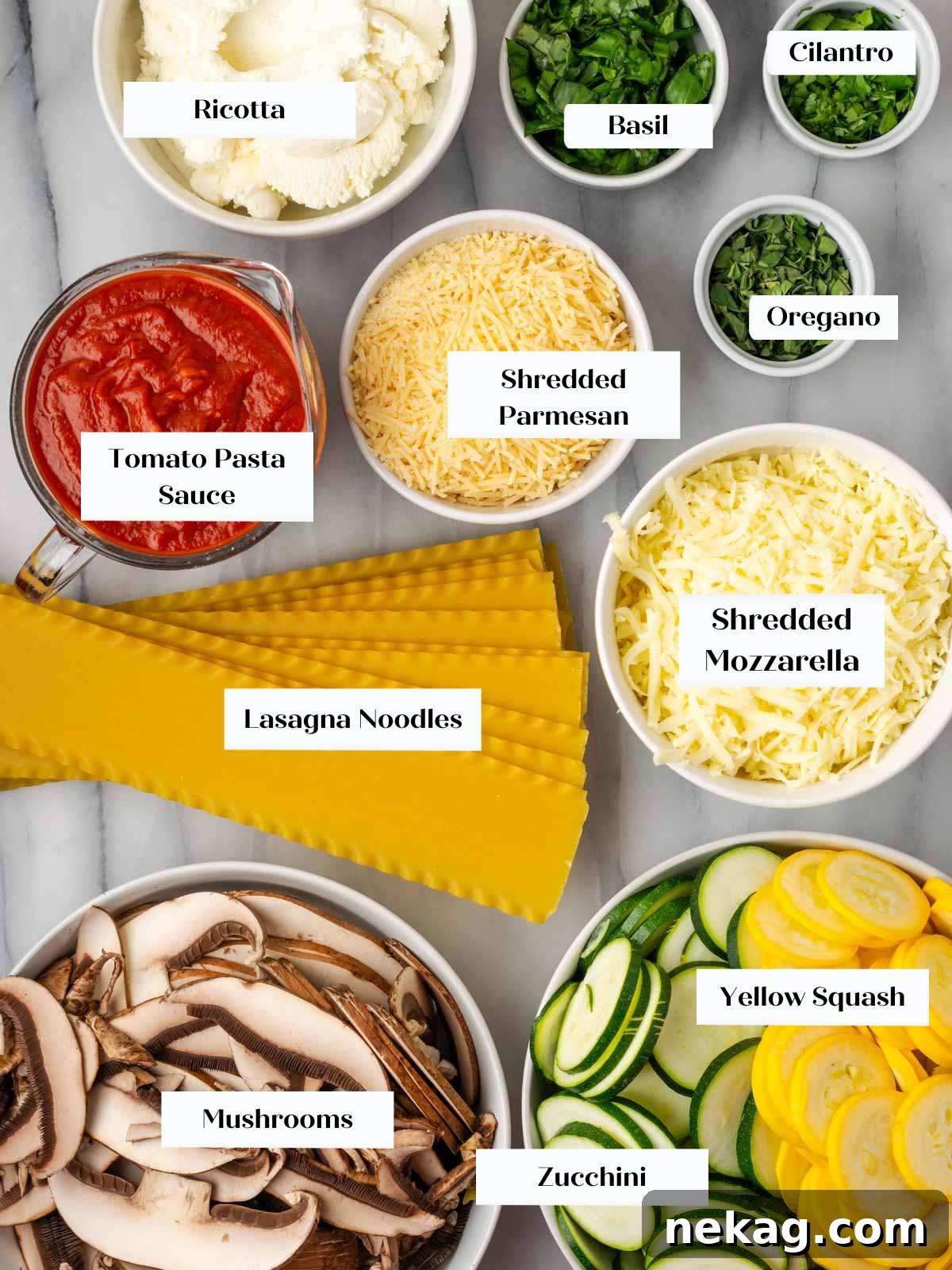 Seasonal Vegetable Lasagna 4 A vibrant display of fresh ingredients for vegetable lasagna laid out on a white marble surface, including zucchini, squash, mushrooms, cheeses, herbs, and lasagna noodles.