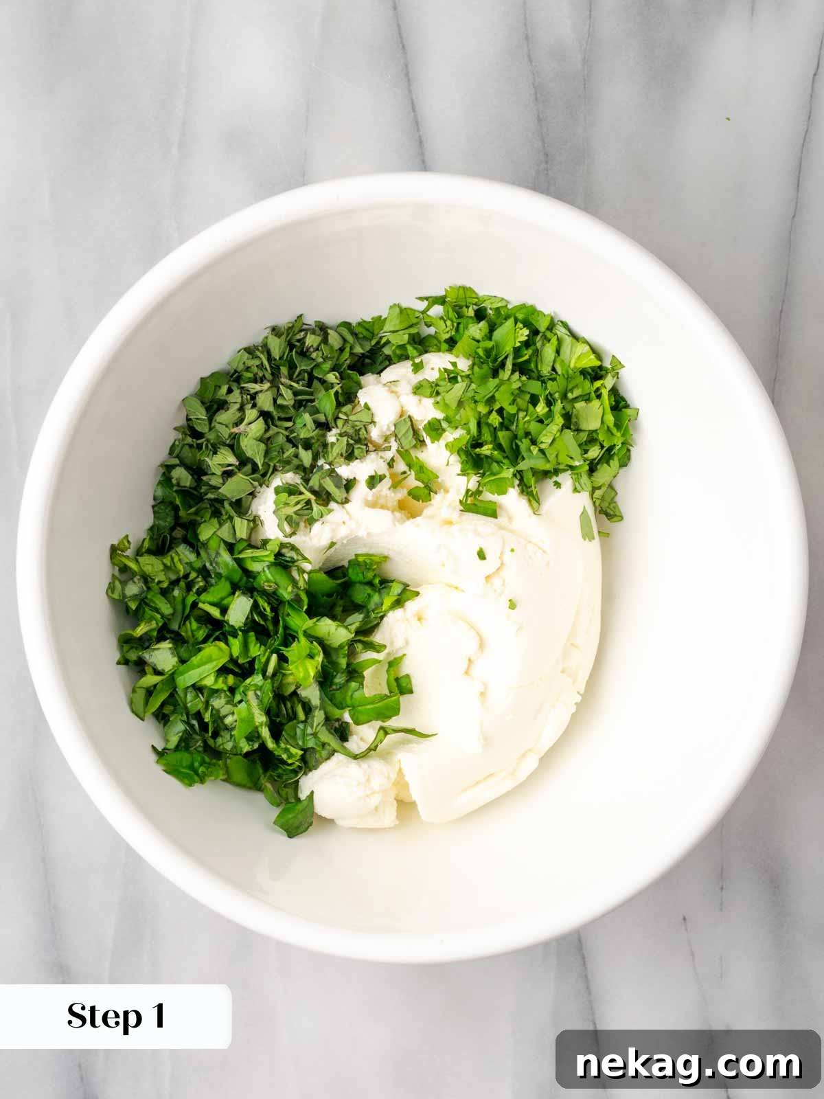 Seasonal Vegetable Lasagna 5 A bowl of creamy ricotta cheese mixed with fresh green herbs, ready for layering in the lasagna.