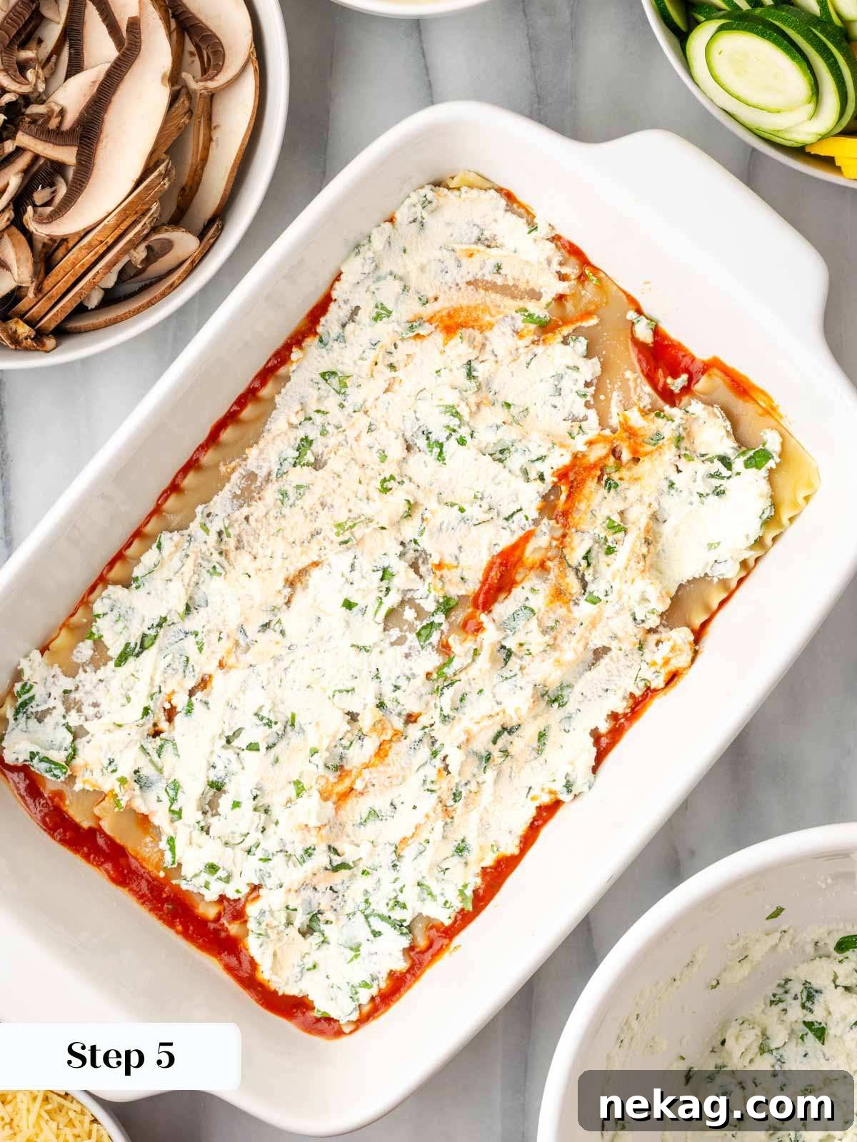 Seasonal Vegetable Lasagna 7 Spreading a layer of the ricotta and herb mixture evenly over the lasagna noodles in the baking dish.