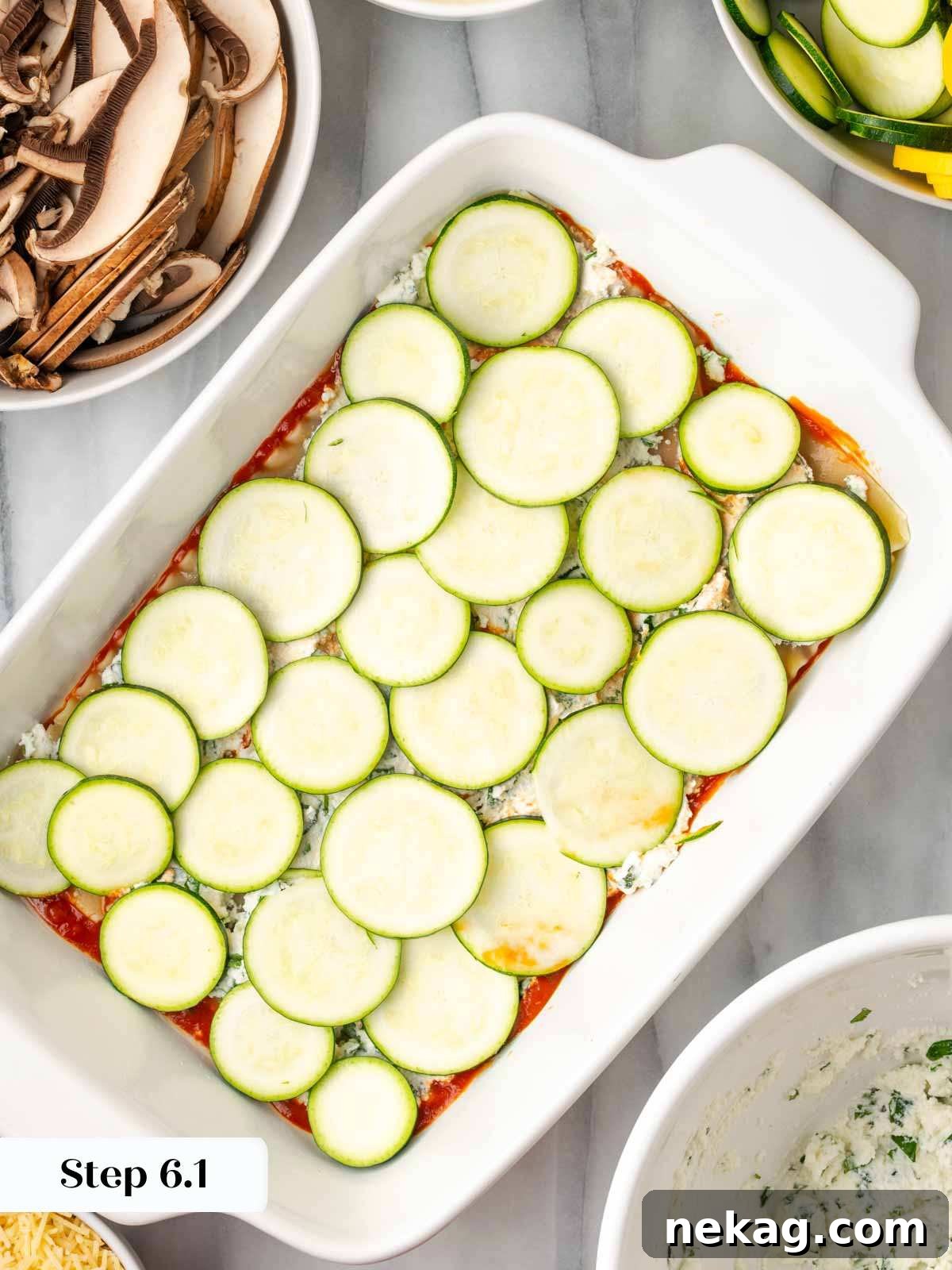 Seasonal Vegetable Lasagna 8 Arranging thinly sliced zucchini over the ricotta layer in the lasagna dish.