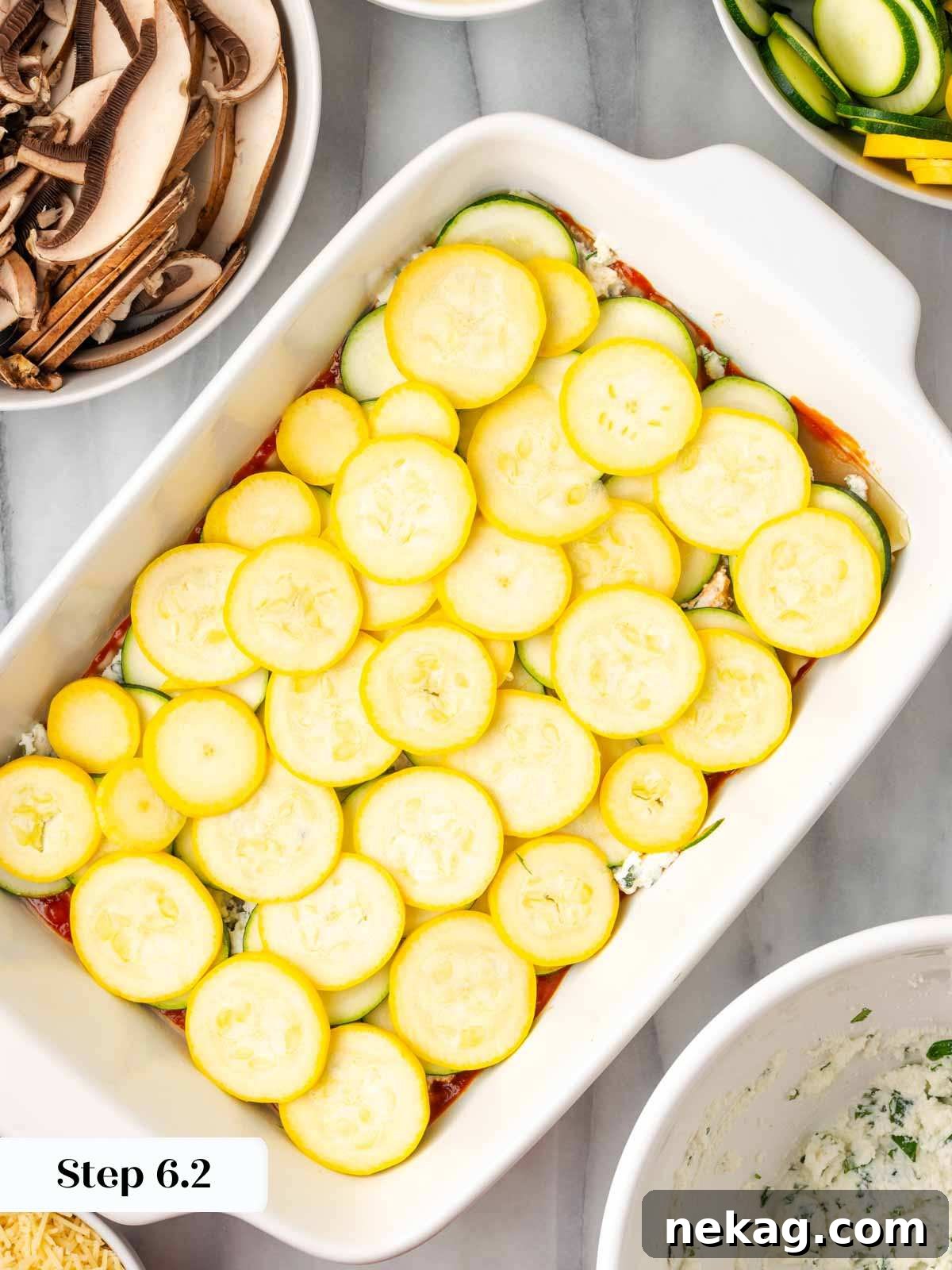 Seasonal Vegetable Lasagna 9 Adding a layer of thinly sliced yellow squash over the zucchini in the lasagna dish.