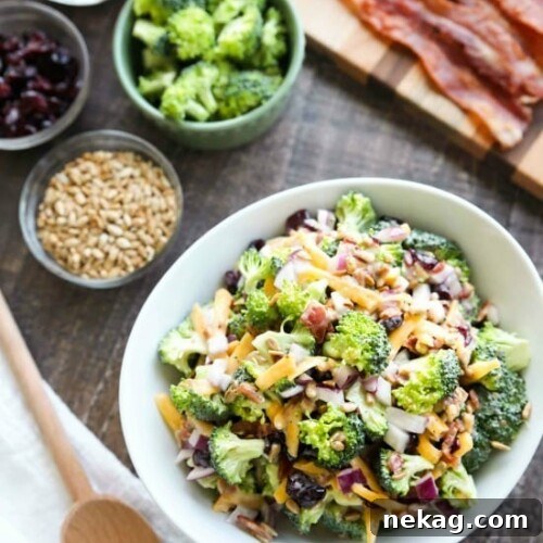 A beautifully presented bowl of creamy broccoli salad, garnished and ready to serve.
