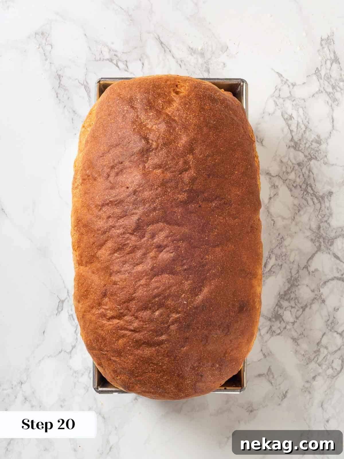 Tender Potato Loaf 21 A fully baked loaf of potato bread in a metal loaf pan, golden and fluffy.