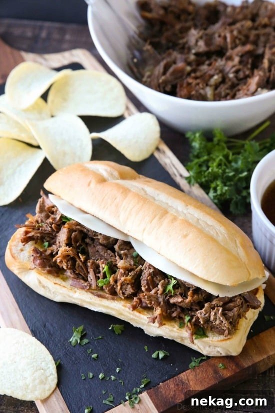 Close-up shot of Instant Pot French Dip Sandwiches, showing the rich, shredded beef and golden toasted rolls.