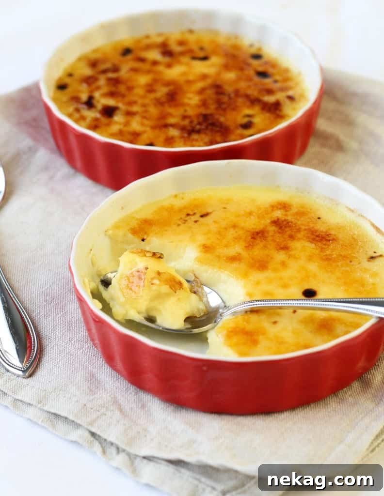 A kitchen torch caramelizing the superfine sugar on top of a Crème Brûlée.