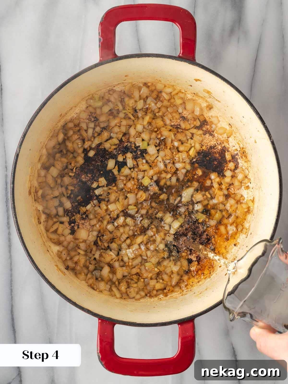 Pouring wine into the Dutch oven to deglaze after browning meat.
