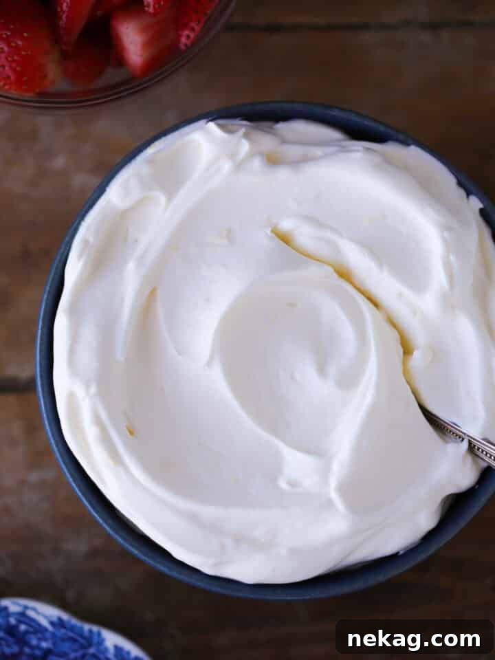 Whipped Citrus Bliss 2 Lemon Whipped Cream in a blue bowl with vintage spoon, ready to be served