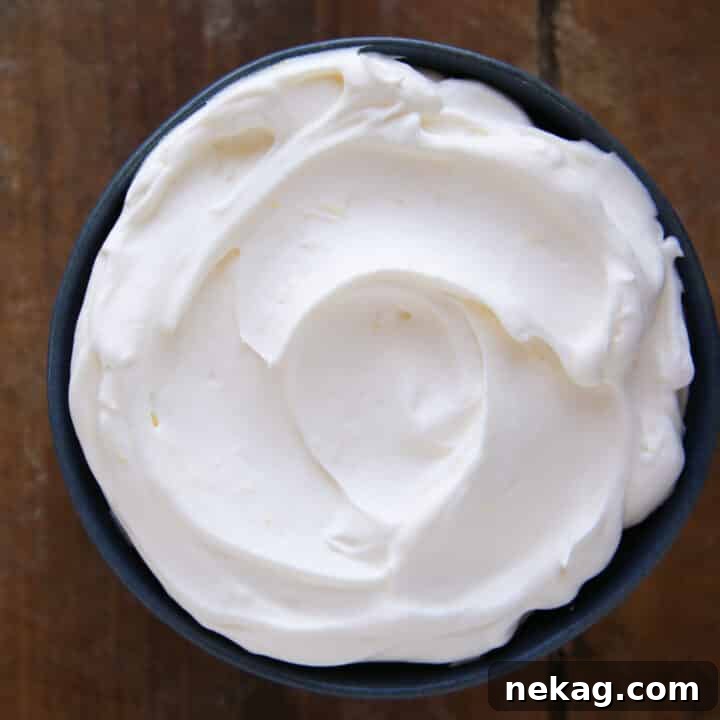 Whipped Citrus Bliss 5 Lemon Whipped Cream beautifully swirled in a blue bowl, showcasing its creamy texture
