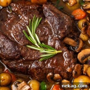 pot roast in dutch oven with assorted vegetables.