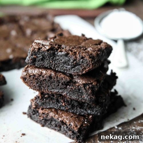 The ultimate fudgy brownie recipe photo, showcasing a perfectly sliced brownie with a soft, moist center.
