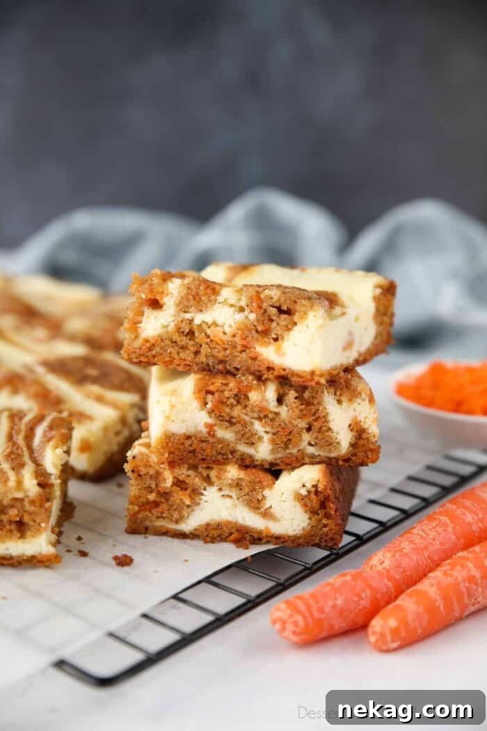 Decadent Carrot Cake Cheesecake Bars 2 Stacked Carrot Cake Cheesecake Bars showing off their marbled layers.