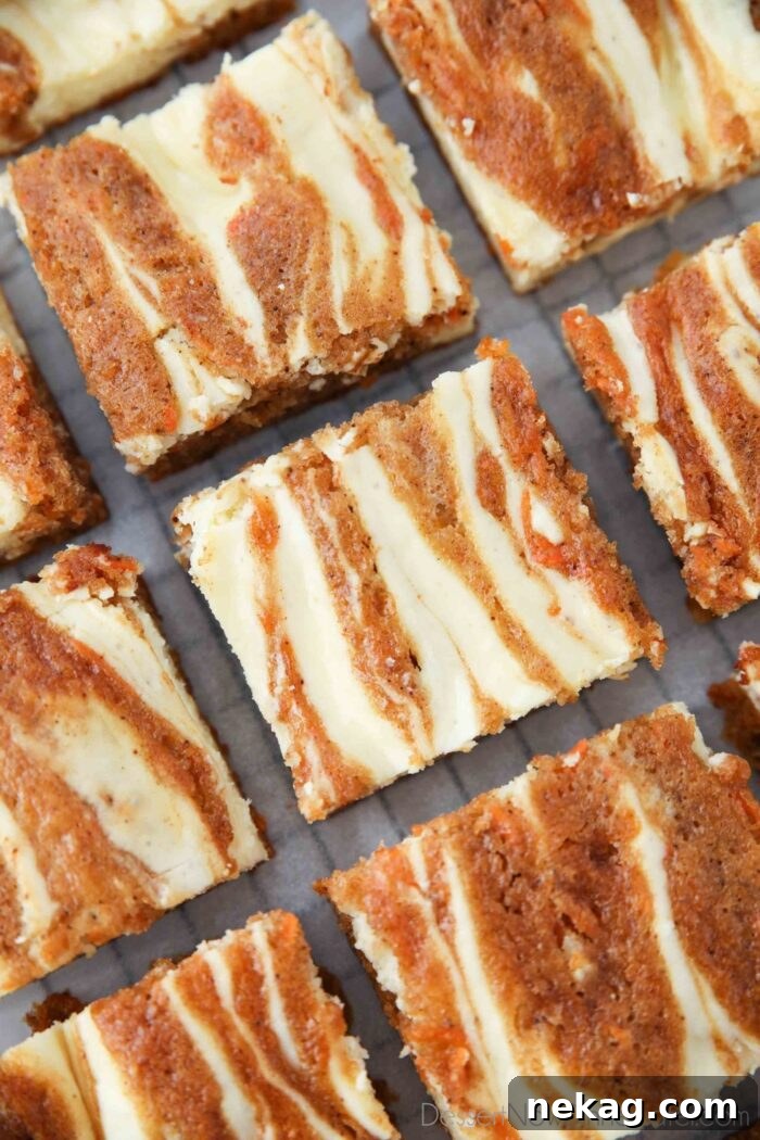 Decadent Carrot Cake Cheesecake Bars 3 Close-up top view of Carrot Cake Blondies, showcasing the beautiful swirls of carrot cake and cheesecake.