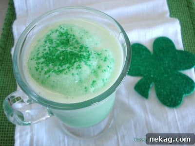 Two glasses of Shamrock Slush, topped with green sugar crystals, ready for serving.
