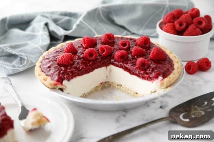 Slices removed from pie pan to show the inside of Raspberry Cream Pie.