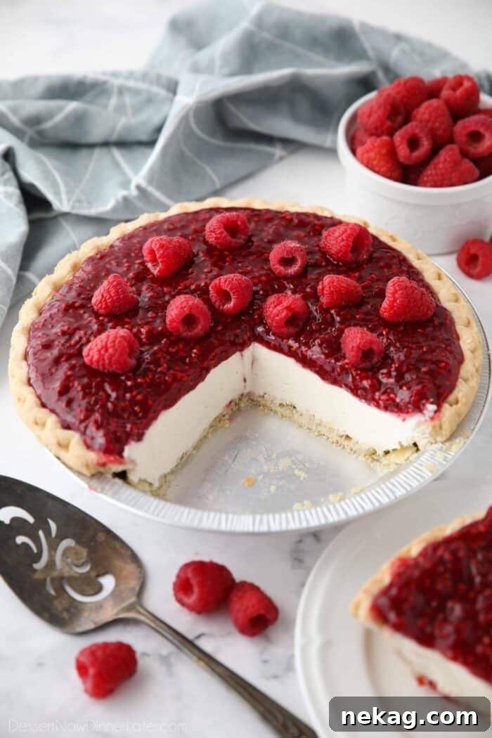 Slices removed from pie pan to show the inside of Raspberry Cream Cheese Pie.