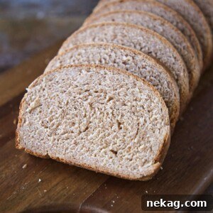 Whole Wheat Breadmaking 3 Whole wheat bread sliced on a cutting board, ready to be enjoyed.