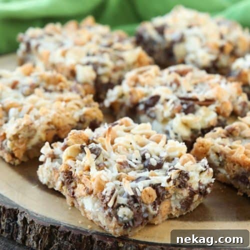 A beautifully composed shot of Seven Layer Bars, featuring the golden crust, melted chips, nuts, and coconut, ready to be enjoyed.
