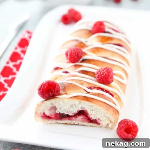 Raspberry Breakfast Braid - a quick raspberry sauce and cream cheese filling are stuffed inside this easy braided bread that's drizzled with a sweet and simple icing. A special breakfast or dessert for weekends or holidays with step-by-step pictures to help you make it.
